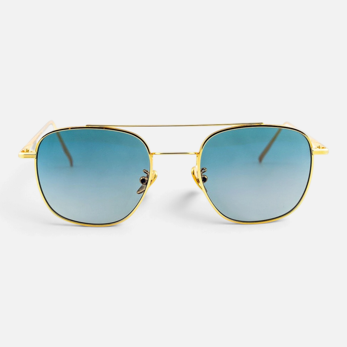 Occhiali da sole Bottega di Sguardi Dentro Concept Dogon con montatura in metallo dorato e lenti sfumate azzurre