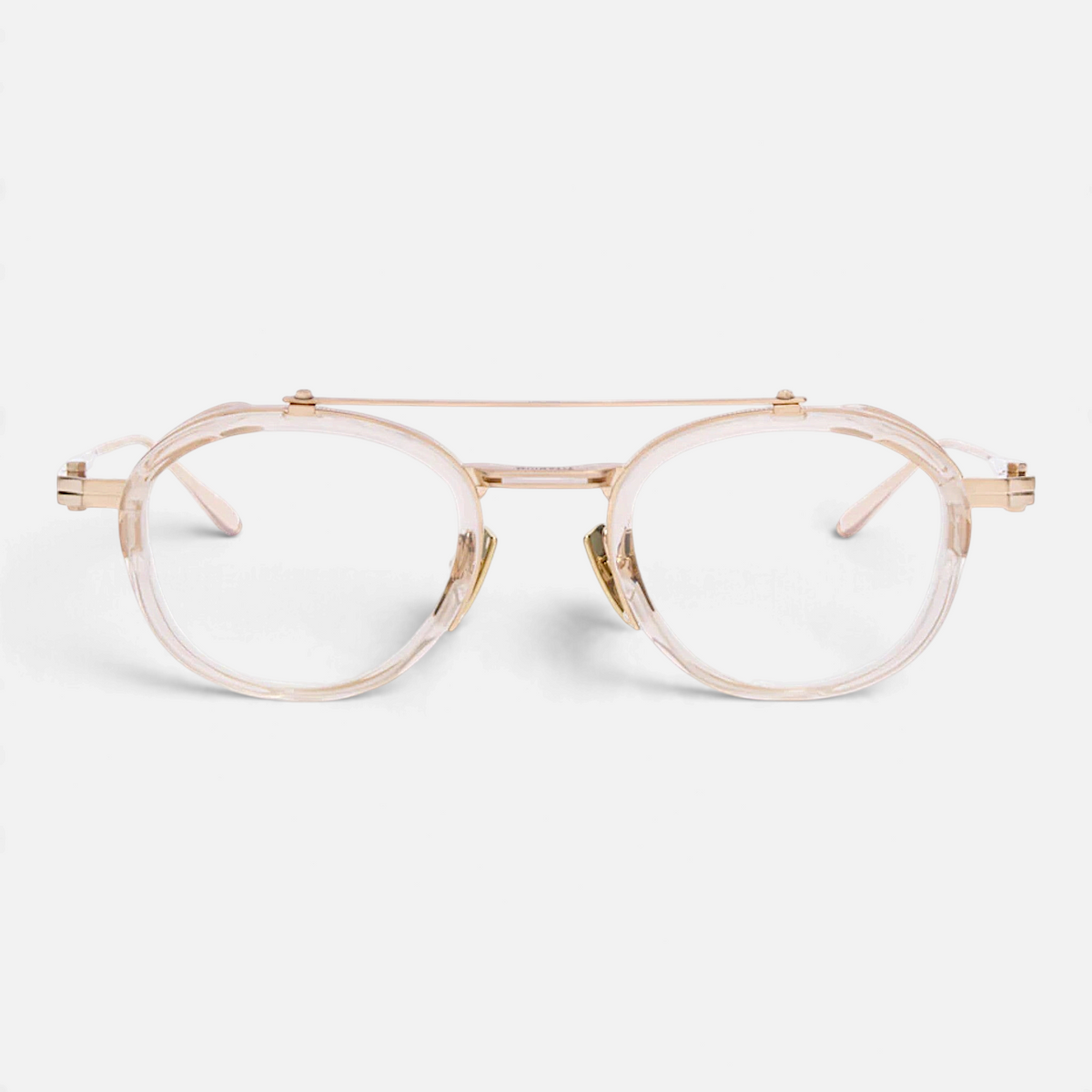 Occhiali da vista Bottega di Sguardi Akoni Infinity con montatura rotonda in acetato trasparente e titanio dorato